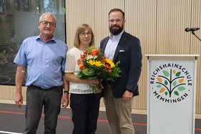 Ehepaar Seitz mit OB, Frau Seitz hält einen Blumenstrauß.