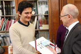 Dr. Holzinger schenke Goshunali eine Mappe mit Informationen über die Stadt Memmingen