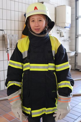Mädchen in Feuerwehrausrüstung